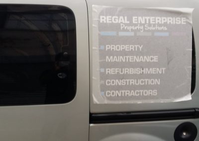 Vehicle signs being applied to the side of the van