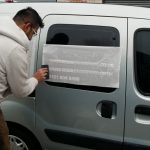 Vehicle livery being applied to the side of the van