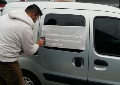 Vehicle livery being applied to the side of the van