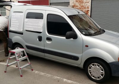 Vehicle livery being applied to the side of the van