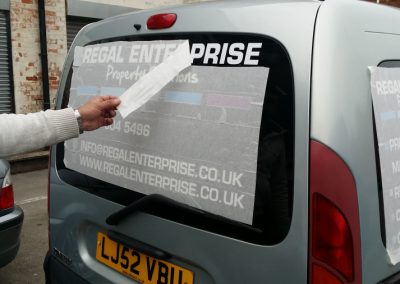 Backing tape being removed from van windows