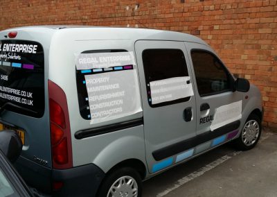 Backing tape being removed from van windows