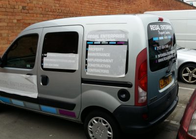 Backing tape being removed from van windows