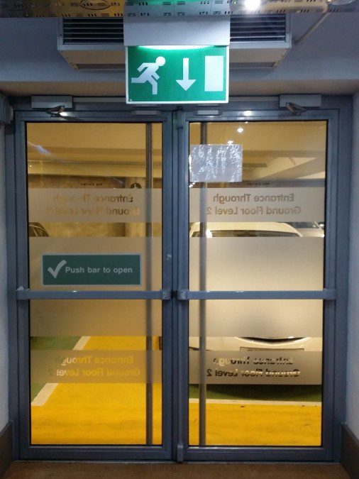 Frosting for a fire exit advising people to use the other entrance