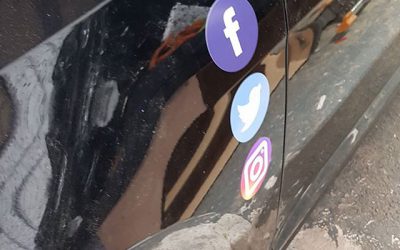 Social media logos being applied to instructors car.#bigprintbirmingham #printingbirmingham #signmaker #signs #printshop #learnercar