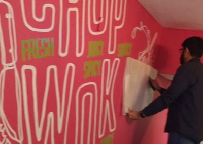 wall vinyls being applied to @chopandwok to place your order whatsapp me mak of big print birmingham