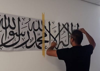 applying this arabic text wall decal to a wall to place your order whatsapp me mak of big print birm 2